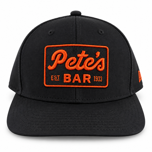 Pete's black snapback hat with orange logo, front view